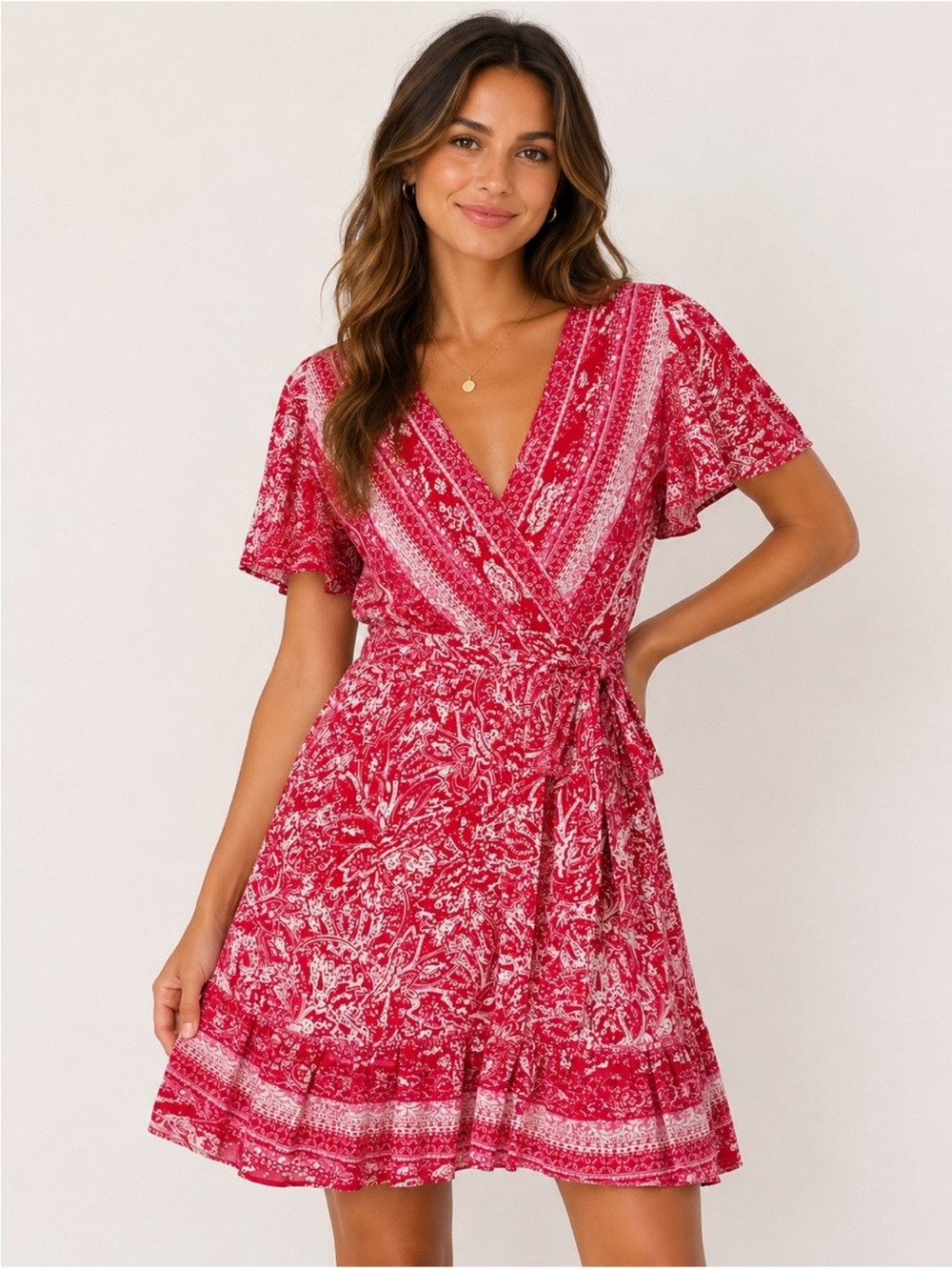 Francesca's pink floral mini dress features a wrap front and flowy short sleeve
